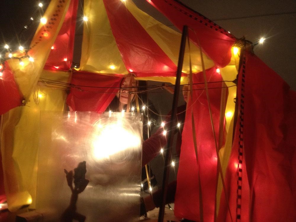 Studio students prepare for characters' live performances beneath the big tent.